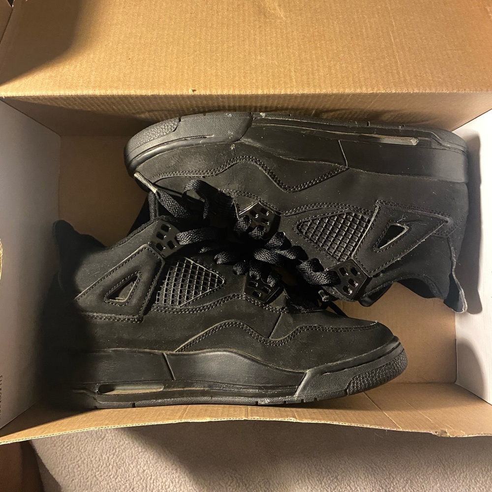 Black cat Jordan 4s. 06